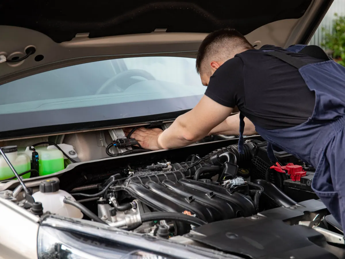 Mechanic working in a car engine bay
