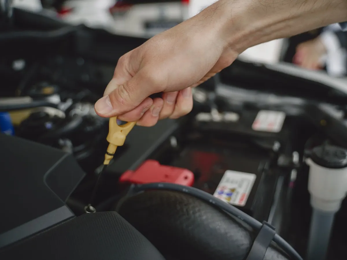 Checking engine oil level with the dipstick